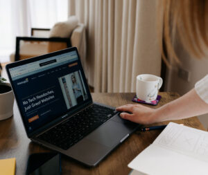 A person reviewing a website on a laptop, analysing how visitors interact with the page