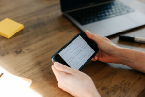 Holding phone looking at AI website SEO